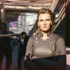Meredith Stout, pewna siebie, stoi na tle miasta. Za nią dwaj mężczyźni z bronią, jeden celuje w jej stronę.