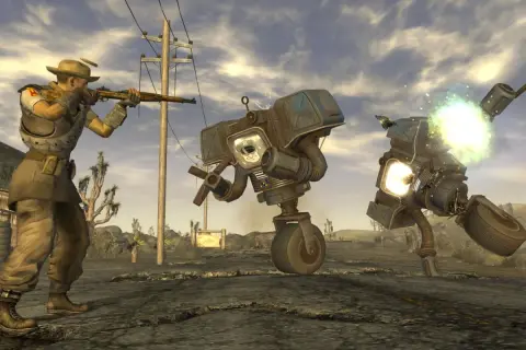 Gracz w kapeluszu strzela do robotów w pustynnym krajobrazie. To scena z najlepszej gry Fallout, pełnej akcji i postapokaliptycznych wyzwań.