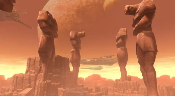 Gigantyczne kamienne posągi na Korribanie, z dwoma statkami kosmicznymi na tle pomarańczowego nieba i planet.