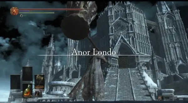 Postać z wielkim młotem przed majestatyczną katedrą w Anor Londo.