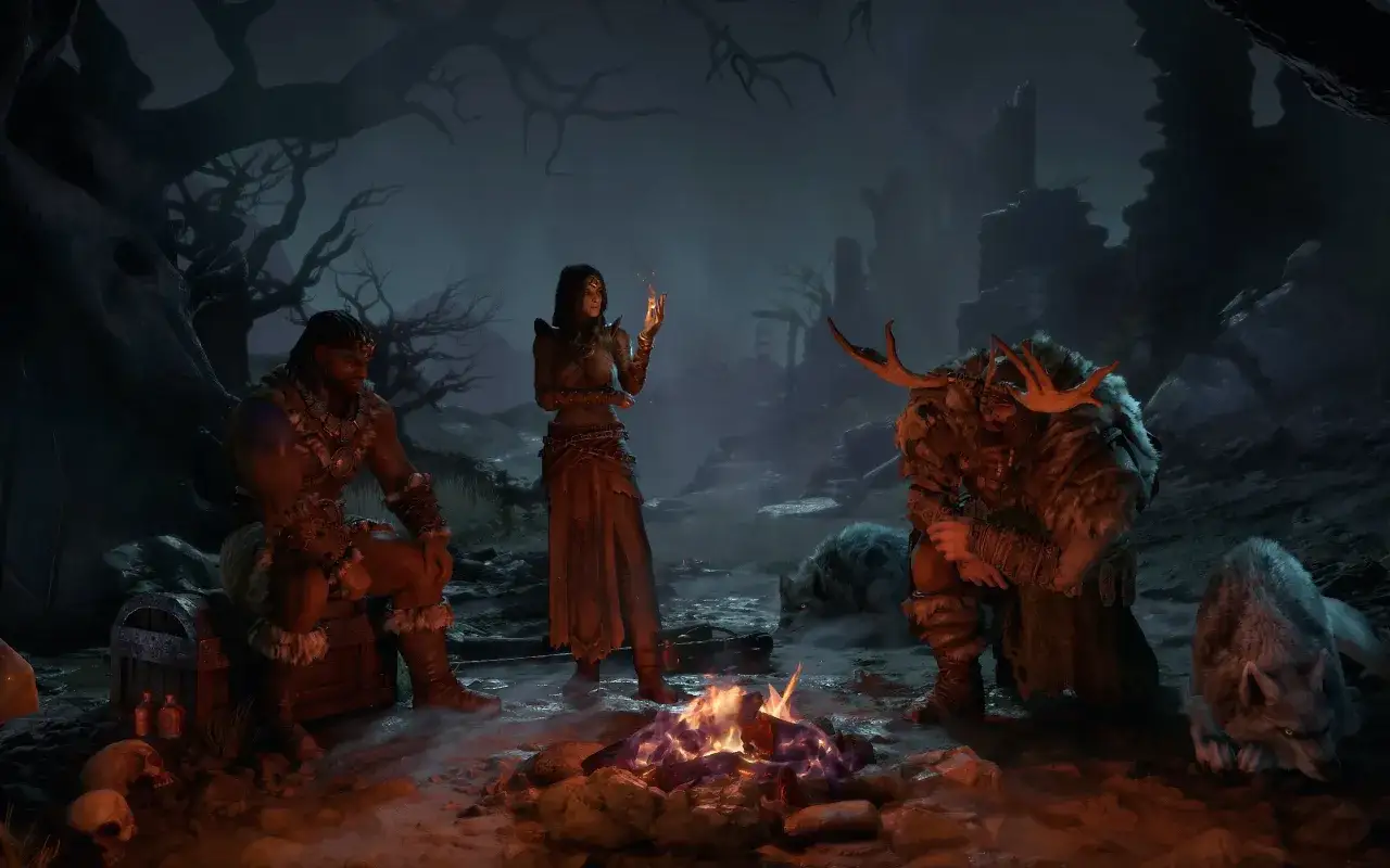 Trzej podróżnicy przy ognisku w mrocznym lesie, z wilkami u boku. Diablo 4 w zgodzie z tradycjami buduje mroczny klimat.